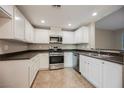 This updated kitchen offers stainless steel appliances, white cabinets, and sleek countertops at 6868 Sky Pointe Dr # 1112, Las Vegas, NV 89131