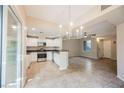 Open concept kitchen with stainless steel appliances, white cabinets, and adjacent dining area at 6868 Sky Pointe Dr # 1112, Las Vegas, NV 89131