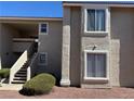 Neutral exterior showcasing the staircase of a well-maintained apartment building on a sunny day at 7300 Pirates Cove Rd # 2054, Las Vegas, NV 89145