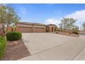 A well-maintained home with a three-car garage, desert landscaping, and a front entrance with columns at 7719 Villa Montara St, Las Vegas, NV 89123