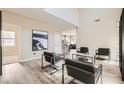 Spacious living room featuring neutral tones, wood-look floors, and modern decor at 8469 Cheerful Brook Ave, Las Vegas, NV 89143