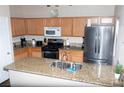 Well-equipped kitchen with stainless steel appliances, granite countertops, and ample cabinet space for easy meal preparation at 9303 Gilcrease Ave # 1077, Las Vegas, NV 89149