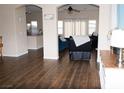 Open-concept living room with wood flooring, neutral paint, and comfortable seating area, creating a warm and inviting atmosphere at 9303 Gilcrease Ave # 1077, Las Vegas, NV 89149