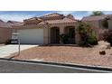 Inviting single-story house featuring a well-kept yard with desert landscaping and a convenient two-car garage at 951 Country Back Rd, Las Vegas, NV 89123