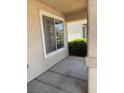 Cozy front porch showcasing a window, textured walls, and inviting concrete flooring at 951 Country Back Rd, Las Vegas, NV 89123