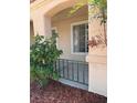 Inviting front porch featuring green foliage, decorative metal railing, and protection from the elements at 951 Country Back Rd, Las Vegas, NV 89123
