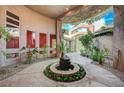 Picturesque courtyard featuring a central fountain, accented by vine-covered walls and a serene ambiance at 9713 Highridge Dr, Las Vegas, NV 89134