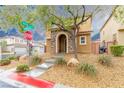 Charming two-story home with a stone-accented entrance and manicured landscaping at 9925 Turquoise Glass Ct, Las Vegas, NV 89178