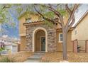 Attractive two-story home showcasing a stone-accented entrance and easy-care landscaping at 9925 Turquoise Glass Ct, Las Vegas, NV 89178