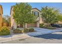 Two-story home with a two-car garage and desert landscaping at 10931 Sardinia Sands Dr, Las Vegas, NV 89141