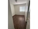 A secondary bedroom featuring modern vinyl floors, ample natural light, and neutral paint at 1153 Stormy Valley Rd, Las Vegas, NV 89123