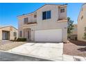 Two-story home with a two-car garage, stucco exterior and tile roof at 1153 Stormy Valley Rd, Las Vegas, NV 89123