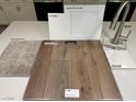 Showcasing flooring samples: carpet, luxury vinyl plank, quartz countertop, cabinet, and faucet at 167 Silver Run Ln, Las Vegas, NV 89138