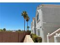 Exterior view of a condo building with palm trees, desert landscaping, and a walkway at 1800 Edmond St # 218, Las Vegas, NV 89146
