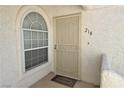Front door of unit #218, featuring an arched window, security door, and 'Welcome' mat at 1800 Edmond St # 218, Las Vegas, NV 89146