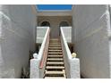 Stairway leading to upper level units with decorative railings and desert landscaping at 1800 Edmond St # 218, Las Vegas, NV 89146