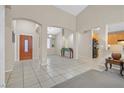 Spacious living area with high ceilings, tile flooring, and an open floor plan flowing into the kitchen at 2309 Tedesca Dr, Henderson, NV 89052