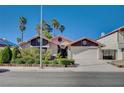 Inviting single-story home with a two-car garage, complemented by well-maintained landscaping and a gated entrance at 2704 Miraflores Ave, Las Vegas, NV 89102