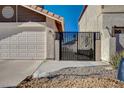View of the garage and wrought iron gate showing the property's exterior features and design elements at 2704 Miraflores Ave, Las Vegas, NV 89102