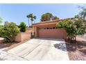 Two-car garage featuring an extended driveway and desert landscaping at 3246 Brookfield Dr, Las Vegas, NV 89120