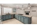 Kitchen boasts granite countertops, blue cabinets, and stainless steel appliances at 3246 Brookfield Dr, Las Vegas, NV 89120
