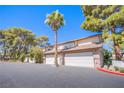 Spacious townhome featuring multiple garage doors and mature trees in a well-maintained neighborhood at 3249 Dayflower St # C, Las Vegas, NV 89121