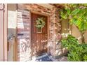 Close-up of the welcoming wood front door with glass insert and decorative floral wreath at 3249 Dayflower St # C, Las Vegas, NV 89121