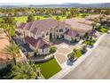 Aerial view of a white home with a large yard and lush landscaping at 35 Ventana Canyon Dr, Las Vegas, NV 89113