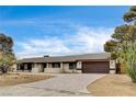 Charming single story home featuring desert landscaping and a two car garage at 3575 W Robindale Rd, Las Vegas, NV 89139