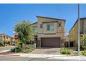 Inviting two-story home with desert landscaping, paver driveway, and a two-car garage in a modern community at 4503 Meteora Ledge Ave, North Las Vegas, NV 89084
