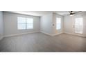 Spacious living room with white walls, wood-style flooring, and bright natural light from the windows at 5055 W Hacienda Ave # 1097, Las Vegas, NV 89118