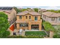 Backyard view of a home with turf grass, a patio, wrought iron fence, and covered patio area at 617 Apricot Rose Pl, Las Vegas, NV 89138