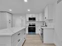 Modern kitchen with white cabinets, sleek countertops, stainless steel appliances, and a stylish center island at 617 Stanford St, Las Vegas, NV 89107