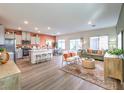 Open-concept living room with ample seating, a kitchen island, and a dining area for entertaining at 6525 Cinnamon Hazelnut St # Lot 92, North Las Vegas, NV 89084