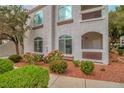 Multi-story condo building with manicured landscaping including flowering bushes and mulch at 700 Carnegie St # 3913, Henderson, NV 89052