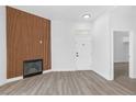 Living room featuring wood-look flooring, a modern fireplace, and a bright white interior at 700 Carnegie St # 3913, Henderson, NV 89052