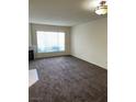 Spacious living room featuring neutral walls, and a fireplace at 7131 S Durango Dr # 104, Las Vegas, NV 89113