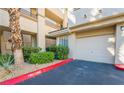 Attached garage with landscaped curb appeal at 7189 S Durango Dr # 203, Las Vegas, NV 89113