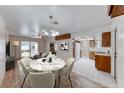 Open dining area features a modern chandelier, adjacent to the kitchen and living spaces at 729 Scottsdale St, Henderson, NV 89002