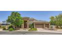 Charming single-story home featuring a three-car garage, brick-paved driveway, and a welcoming stone facade at 7418 Lawrence Powers Ct, Las Vegas, NV 89129