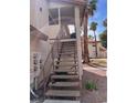 Staircase leading to an upper unit, next to utilities, with palm trees and part of the roof visible nearby at 809 Rock Springs Dr # 202, Las Vegas, NV 89128