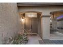 Covered front porch with double doors, decorative columns, and desert landscaping for curb appeal at 8208 Fritzen Ave, Las Vegas, NV 89131