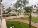 Attractive front yard featuring fresh grass, a paver walkway, and lush plantings at 9028 Cypress Point Way, Las Vegas, NV 89117