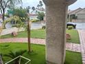 Well-maintained front yard showcases lush grass, a paver walkway, and healthy green shrubs, providing great curb appeal at 9028 Cypress Point Way, Las Vegas, NV 89117