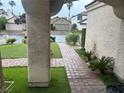 Paver walkway with fresh grass and palm trees leads to the home's front door at 9028 Cypress Point Way, Las Vegas, NV 89117