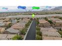 Stunning aerial view of the neighborhood with city and mountain views, showcasing the home's desirable location at 10617 Hartford Hills Ave, Las Vegas, NV 89166