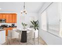 Cozy dining area featuring stylish chandelier lighting, table setting, and lots of natural light at 10617 Hartford Hills Ave, Las Vegas, NV 89166