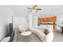 Open-concept living room with views of kitchen, complete with modern furniture and neutral decor at 10617 Hartford Hills Ave, Las Vegas, NV 89166