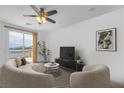 Bright living room featuring neutral furniture, large windows, and a view of the surrounding area at 10617 Hartford Hills Ave, Las Vegas, NV 89166
