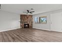 Open living area with a stone fireplace and neutral walls, plus lots of sunlight at 1112 Observation Dr # 201, Las Vegas, NV 89128